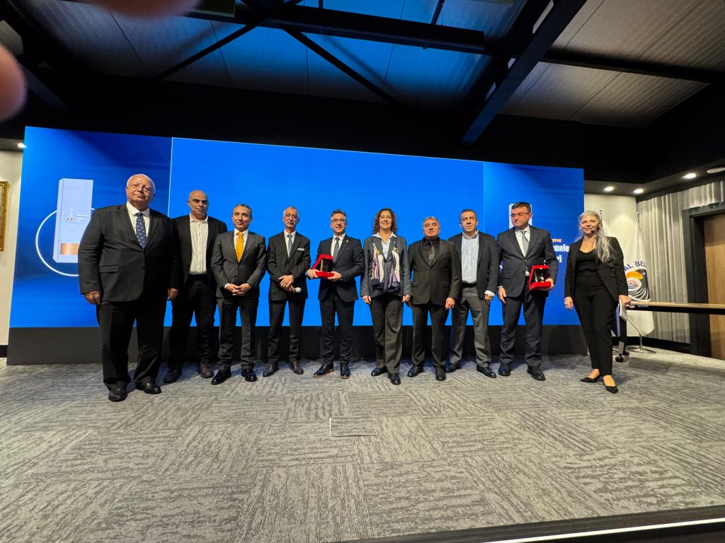The Betek team standing proudly on stage to accept the "Investment of the Year" award for their Water-Based Paint Production Facility.