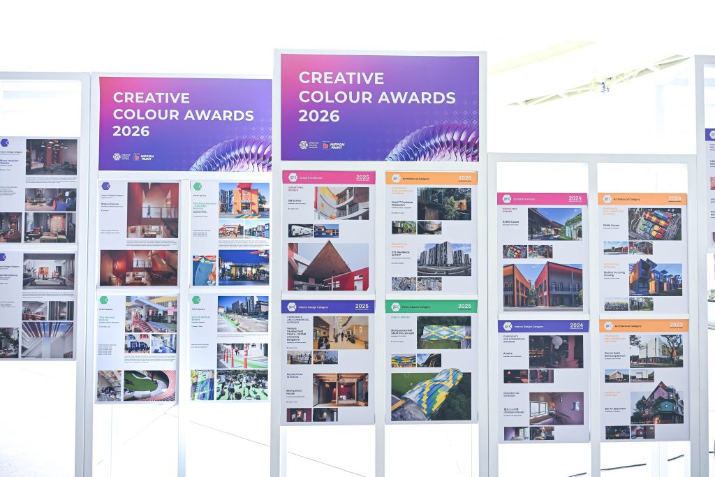 Large display boards showcasing architectural and interior design project posters at the event.