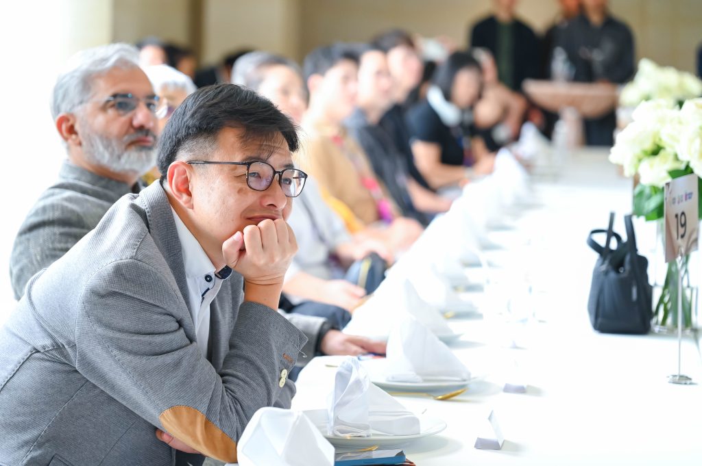 An engaged audience member watching the Creative Colour Awards ceremony intently.