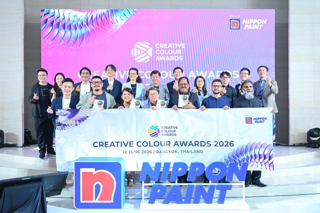 A large group photograph featuring all event attendees and jury members holding the awards banner.