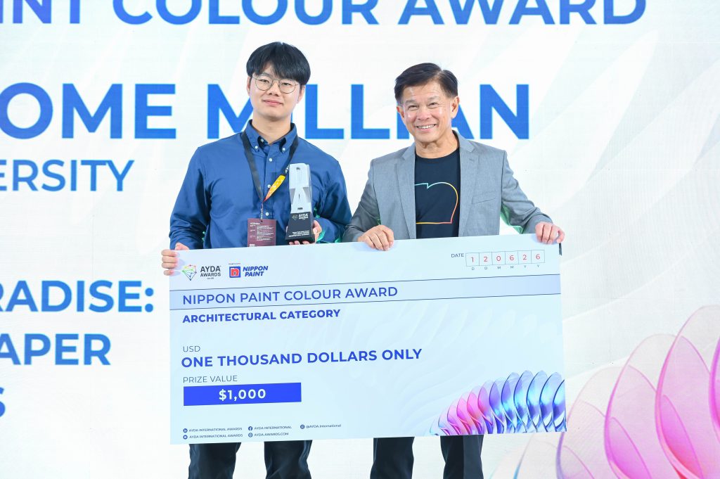 Shiu Jerome Millian smiles while holding his silver award trophy and prize cheque with Mr Wee Siew Kim.