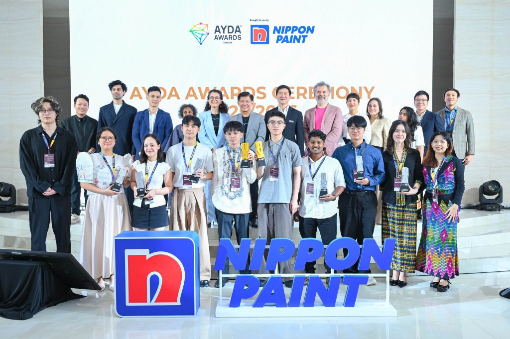 The outstanding AYDA Awards category winners holding their silver trophies on stage alongside the panel of international judges.