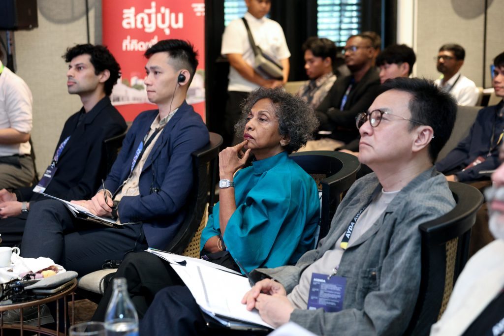 Close-up of thoughtful judges, including a woman in a teal top, focusing on the stage.