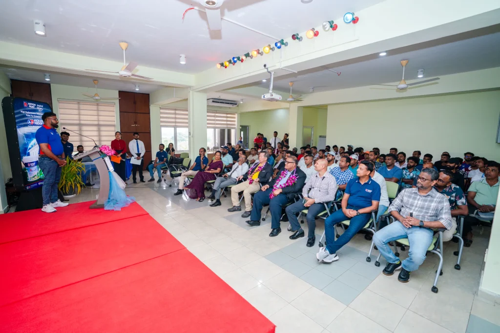A speaker addresses a seated audience at the Nippon Paint Painters Academy event.